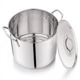A stainless steel stockpot with side handles and a matching glass lid leaning against it on a white background.