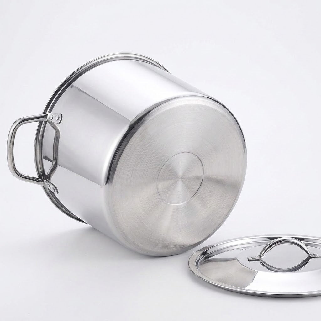 A stainless steel stockpot with a matching lid, shown on a clean white background. The pot is positioned on its side to display the bottom and side handle, with the lid resting beside it.