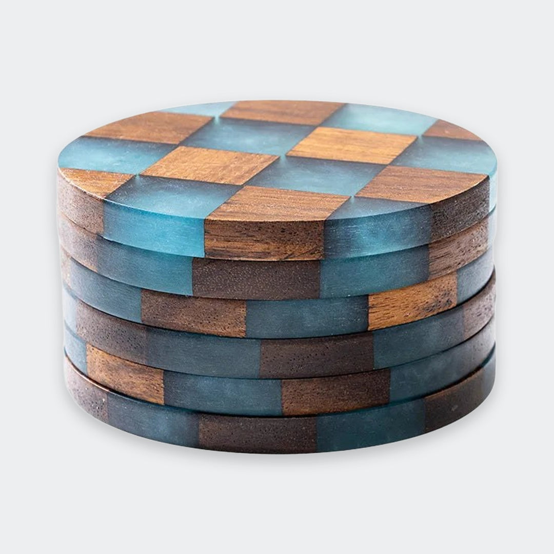 A stack of round wooden coasters with a checkered pattern of natural brown wood and translucent blue-green resin, shown on a light gray background.