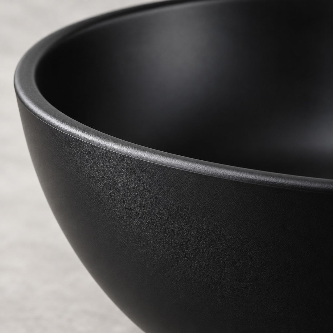 A close-up shows the smooth satin finish and rounded rim of a black Japanese-style bowl.