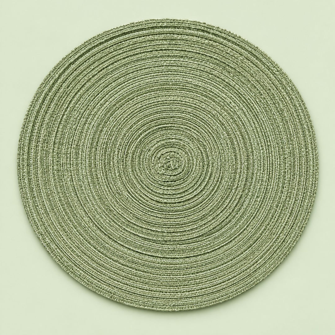 Single green round woven polyester placemat centered on a softly tinted pale green studio background.