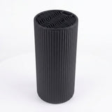 A black ribbed cylindrical vase or candle holder with a wavy pattern on the top surface, shown on a white background.