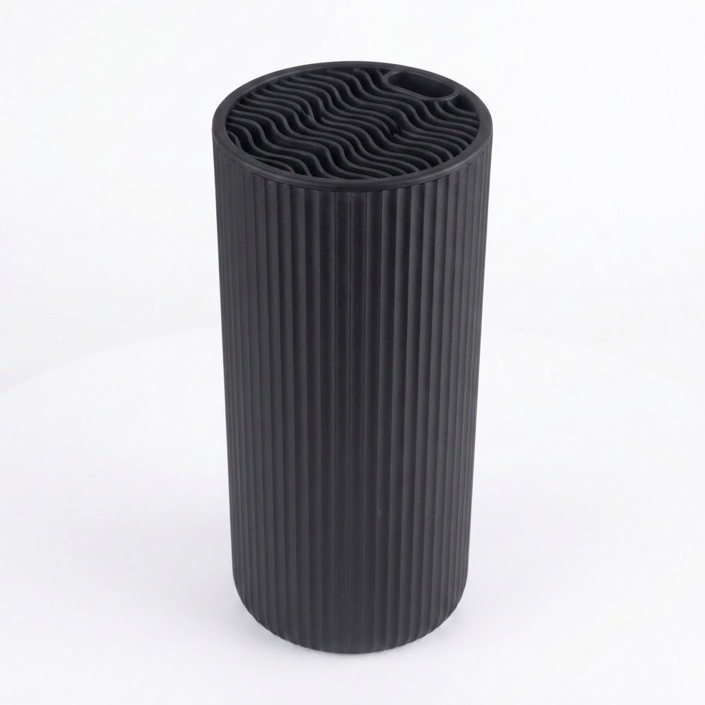 A black ribbed cylindrical vase or candle holder with a wavy pattern on the top surface, shown on a white background.