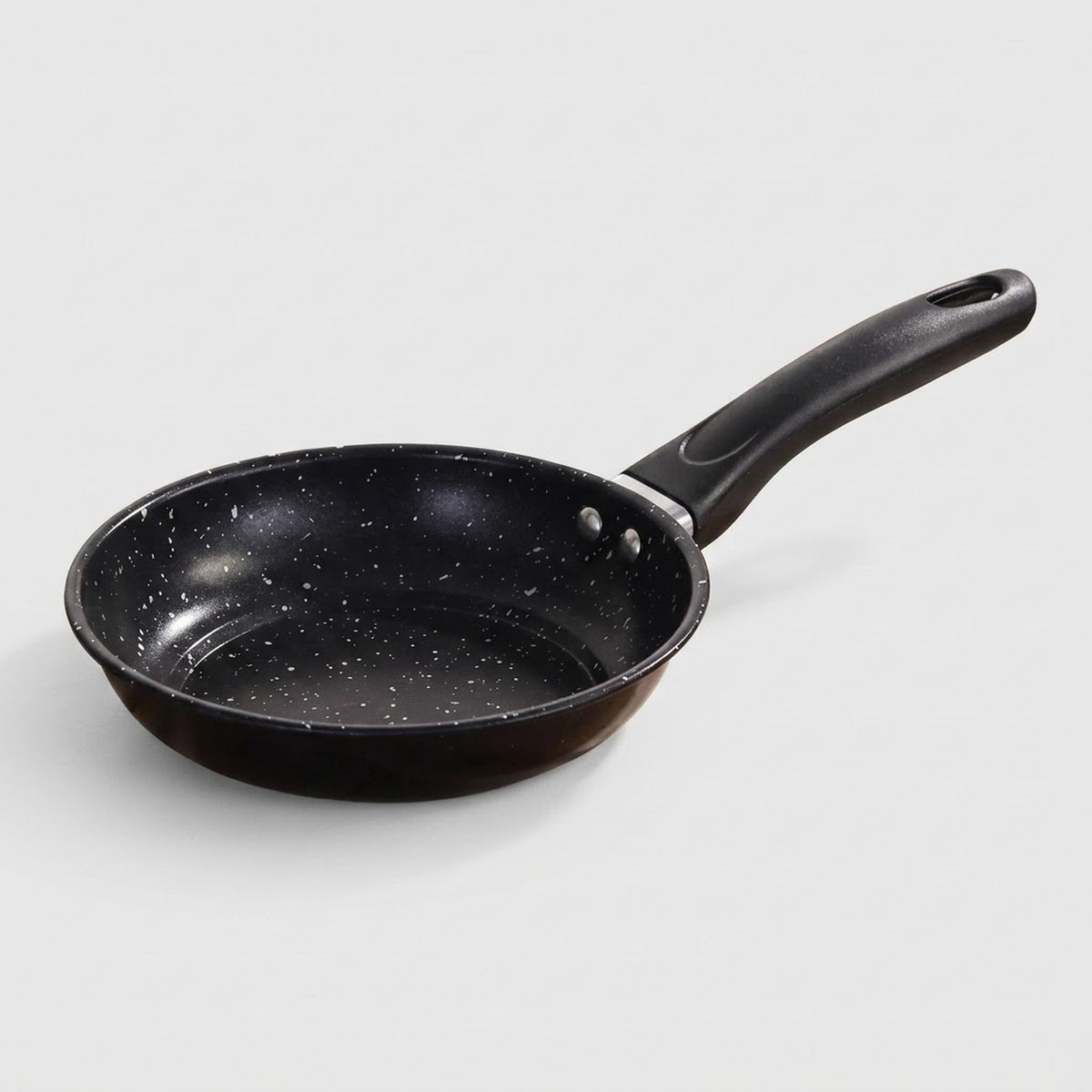 A black non-stick frying pan with white speckled pattern and a black handle, shown on a light gray background.