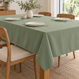 Sage green polyester tablecloth covers a dining table for a simple, protected everyday setting.
