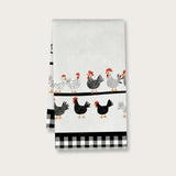 A white kitchen tea towel featuring a pattern of black and white chickens with red combs and yellow beaks, along with a black and white gingham check border at the bottom, shown against a light gray background.