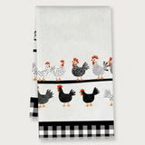 A white kitchen tea towel featuring a pattern of black, white, and red chickens, with a black and white gingham checkered border at the bottom.