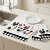 A set of kitchen towels with a black and white gingham border and a chicken pattern, displayed on a cream kitchen counter next to a sink and a white plate.