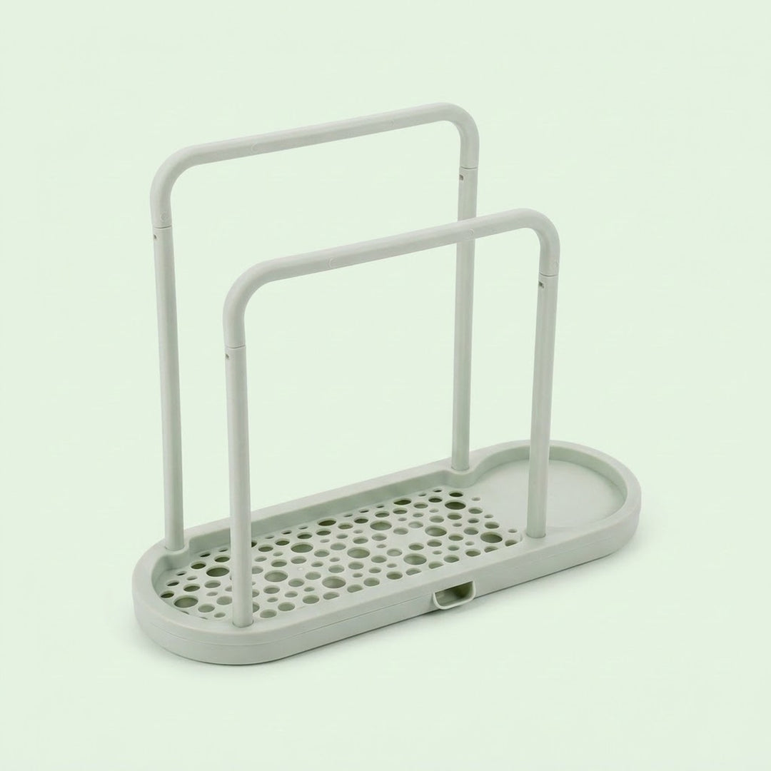 A light gray plastic organizer tray with two upright handles and a perforated base, shown on a pale mint green background.