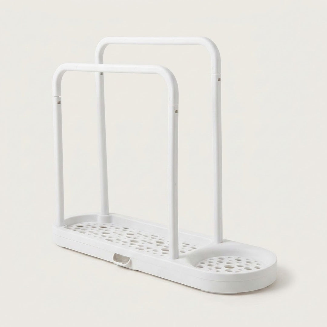 A white plastic double-tier shower caddy with a perforated base and integrated drain tray, shown on a light beige background.