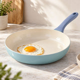 Ceramic Glaze Nonstick Frying Pan with a smooth ivory cooking surface and easy-release egg.