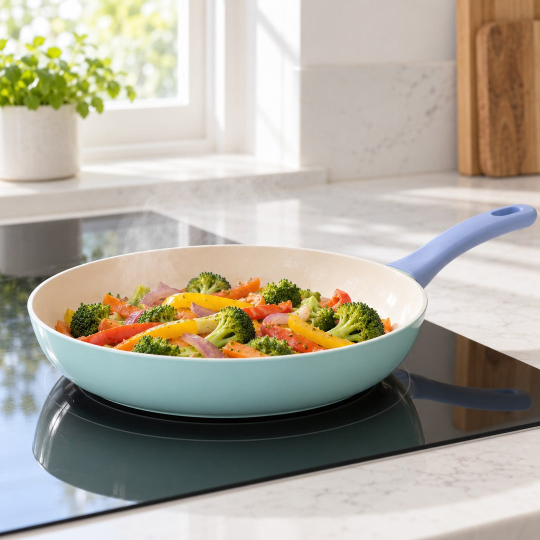 Ceramic Glaze Nonstick Frying Pan cooking vegetables on an induction cooktop in a home kitchen.