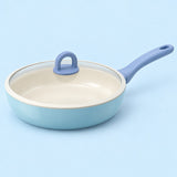 Ceramic Glaze Nonstick Frying Pan with glass lid, centered on a soft blue studio background.