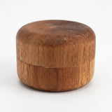 A small round wooden box with a visible wood grain texture, shown on a plain white background.