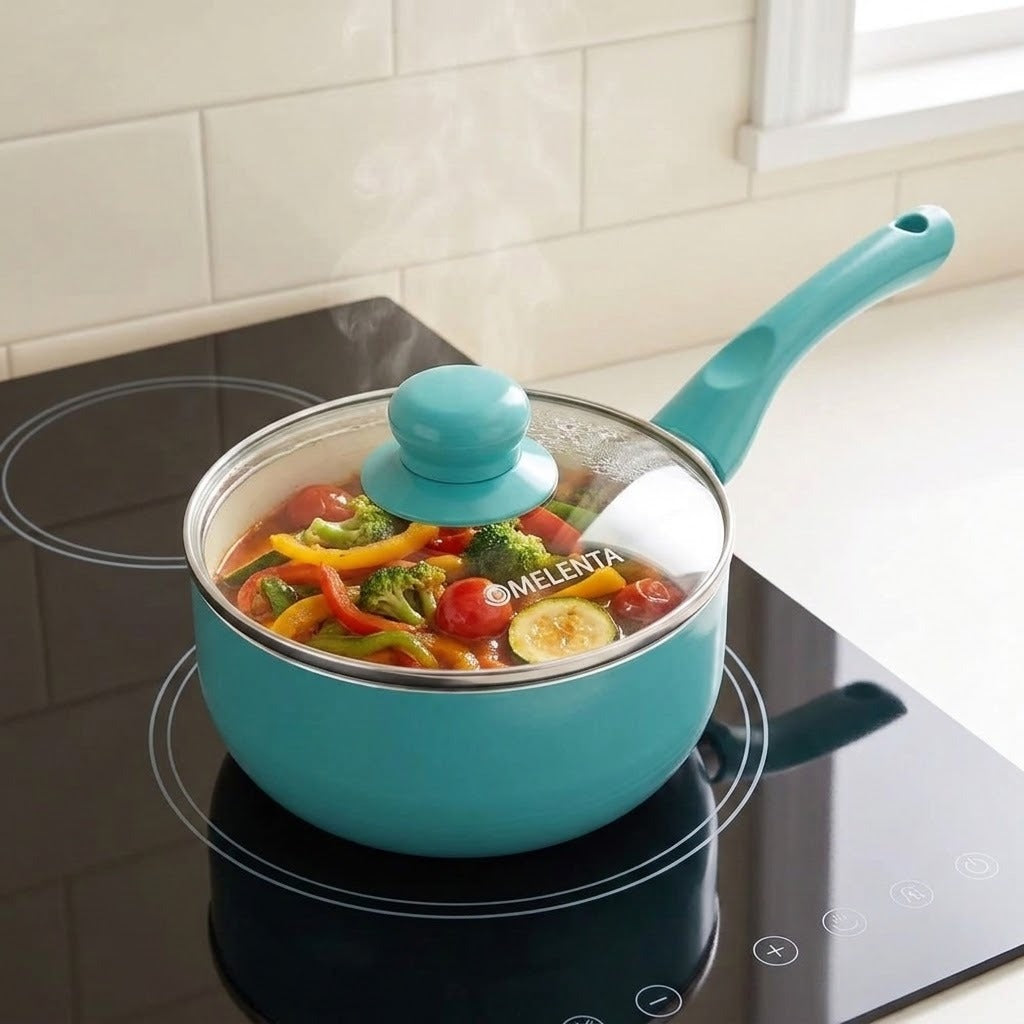 A teal blue saucepan with a clear glass lid and turquoise handle sits on a black induction cooktop, cooking colorful vegetables. The brand name 'MELENTA' is visible on the glass lid.