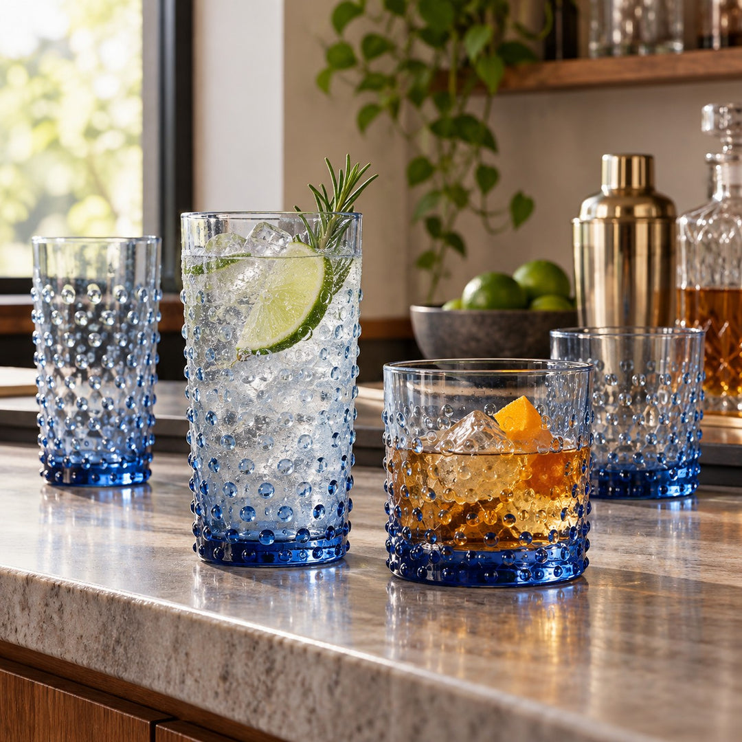 Blue Vintage Hobnail Drinking Glass Set serves cocktails in tall and short glasses on a home bar.