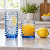 Blue Vintage Hobnail Drinking Glass Set shows tall and short tumblers beside a lemon for scale.