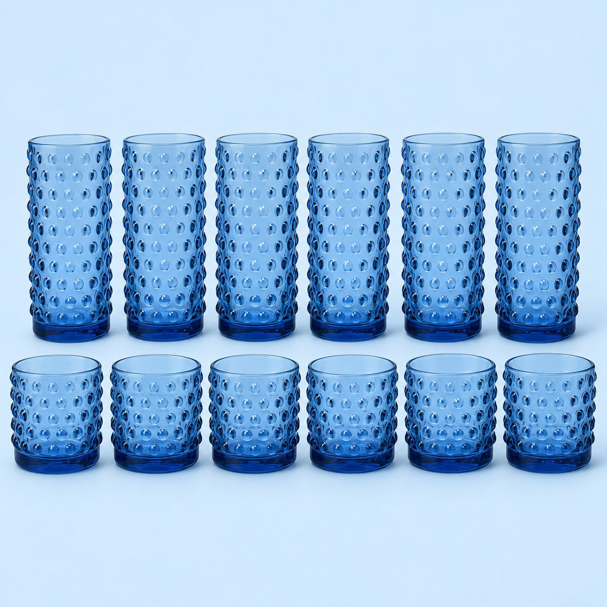 Blue Vintage Hobnail Drinking Glass Set shows twelve matching highball and rocks tumblers on pale blue.
