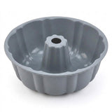 A gray silicone or non-stick bundt cake pan with a fluted rim and central tube, shown on a clean white background.