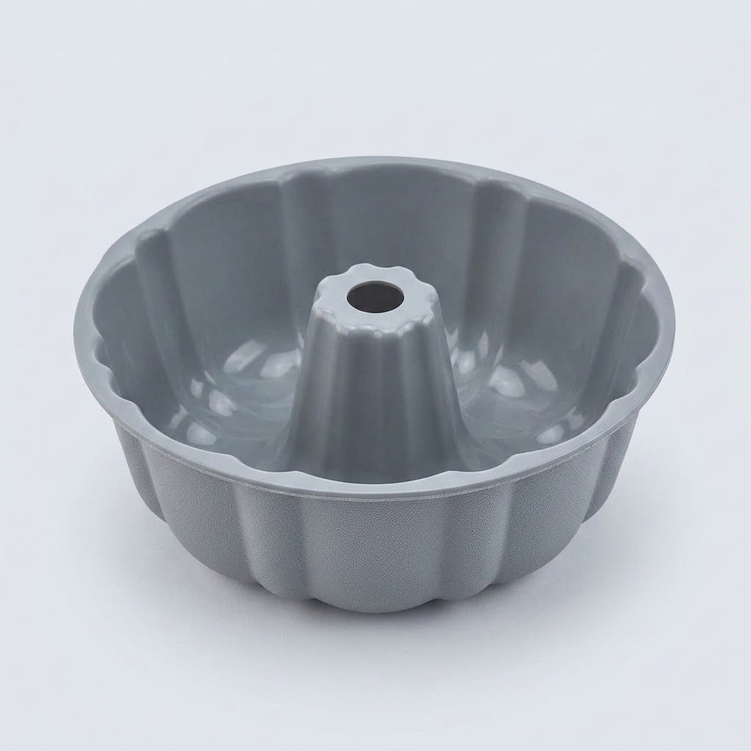 A gray fluted bundt cake pan with a central hole, photographed on a clean white background.