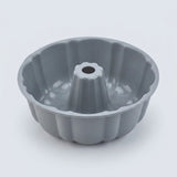 A gray fluted bundt cake pan with a central hole, photographed on a clean white background.
