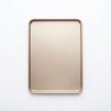 A rectangular metal baking sheet with rounded corners, shown from a top-down view on a clean white background.