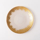 A round ceramic plate with a textured gold finish on the outer rim and a smooth, matte white center, photographed from directly above on a clean white background.