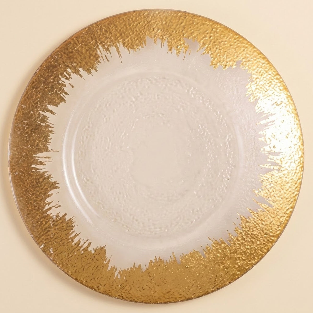 A round white plate with a textured, metallic gold abstract brushstroke border on a light beige background.