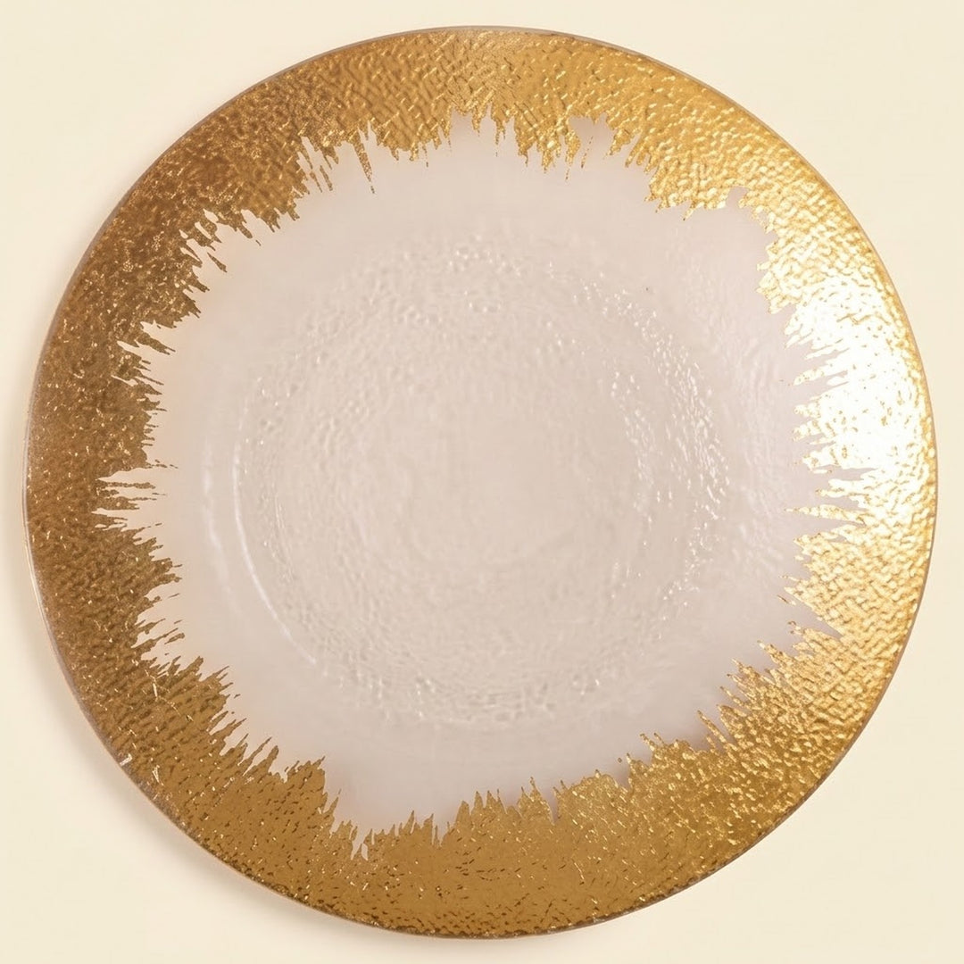 A round white plate with a textured, metallic gold abstract brushstroke border, shown from a top-down view on a light cream background.