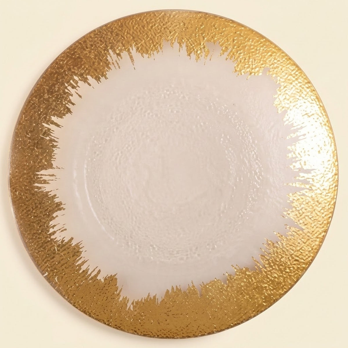A round white plate with a textured, metallic gold abstract brushstroke border, shown from a top-down view on a light cream background.