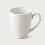 A white ceramic coffee mug with a ribbed vertical texture and a curved handle, shown on a light gray background.