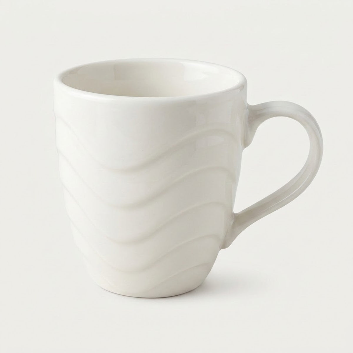A white ceramic coffee mug with a wavy, ribbed pattern and a curved handle, shown on a light gray background.