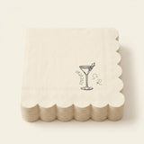 A stack of square off-white paper napkins with scalloped edges, featuring a black line art illustration of a martini glass with an olive and the words 'Groomsmen' alongside a monogram.