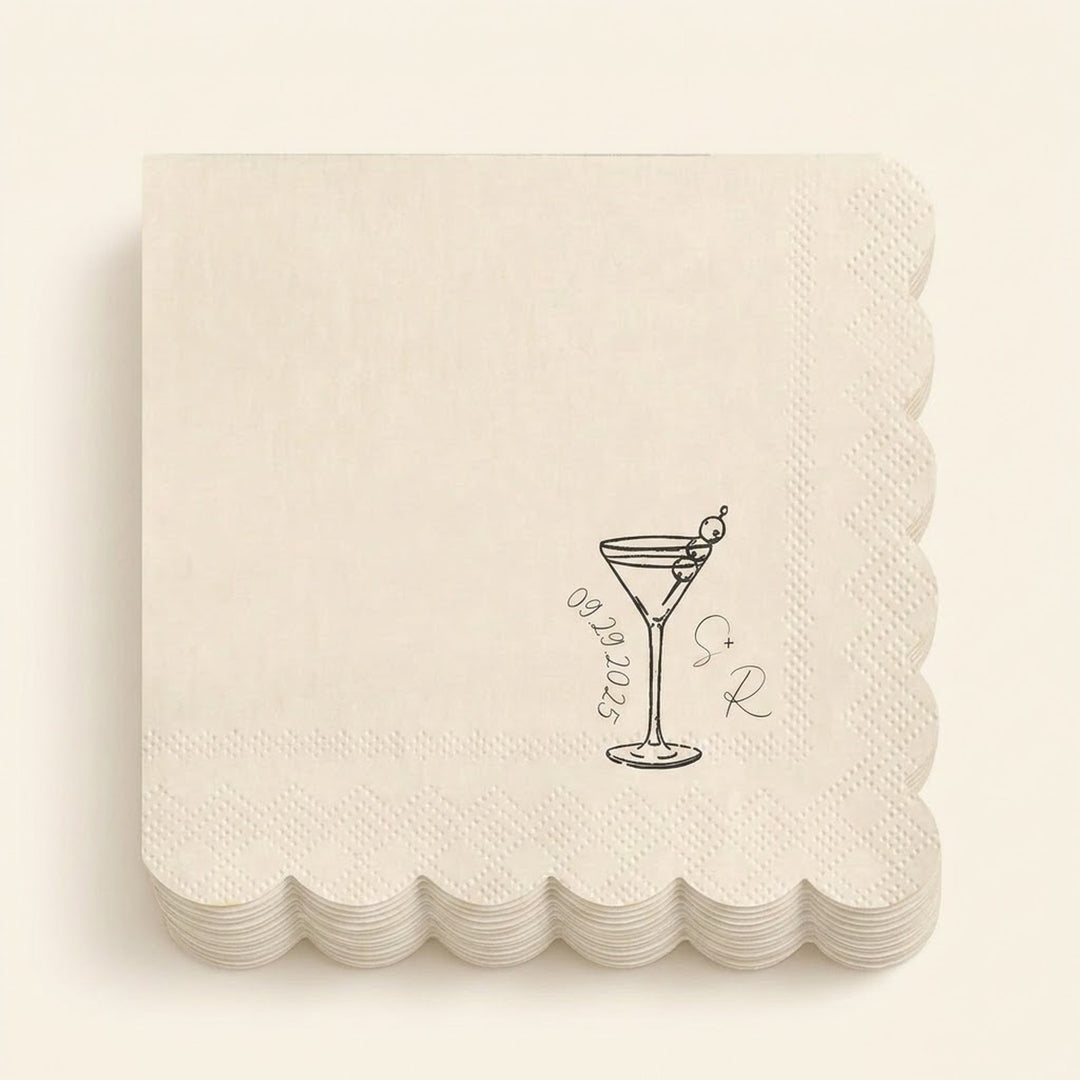 A stack of square off-white paper napkins with scalloped edges, each printed with a small black cocktail glass illustration, the date '09.09.