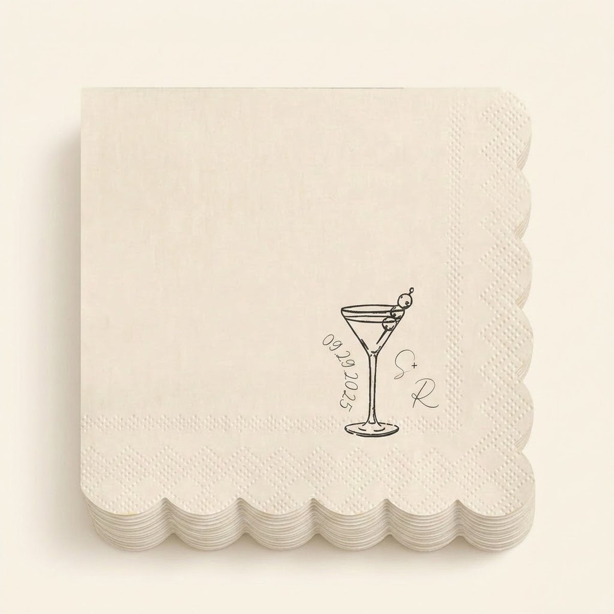 A stack of square off-white paper napkins with scalloped edges, each printed with a small black cocktail glass illustration, the date '09.09.