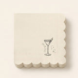 A stack of square off-white paper napkins with scalloped edges, featuring a black line art illustration of a martini glass with an olive, the date '09.28.