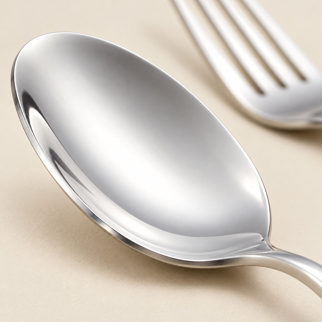 Close-up of the smooth polished stainless steel bowl of a spoon.