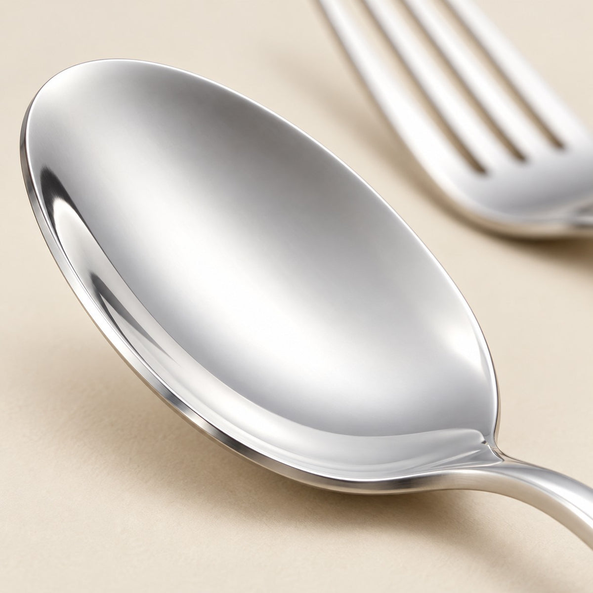 Close-up of the smooth polished stainless steel bowl of a spoon.