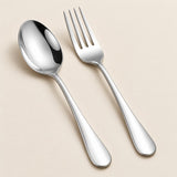Polished stainless steel spoon and fork show a simple coordinated finish on a neutral surface.