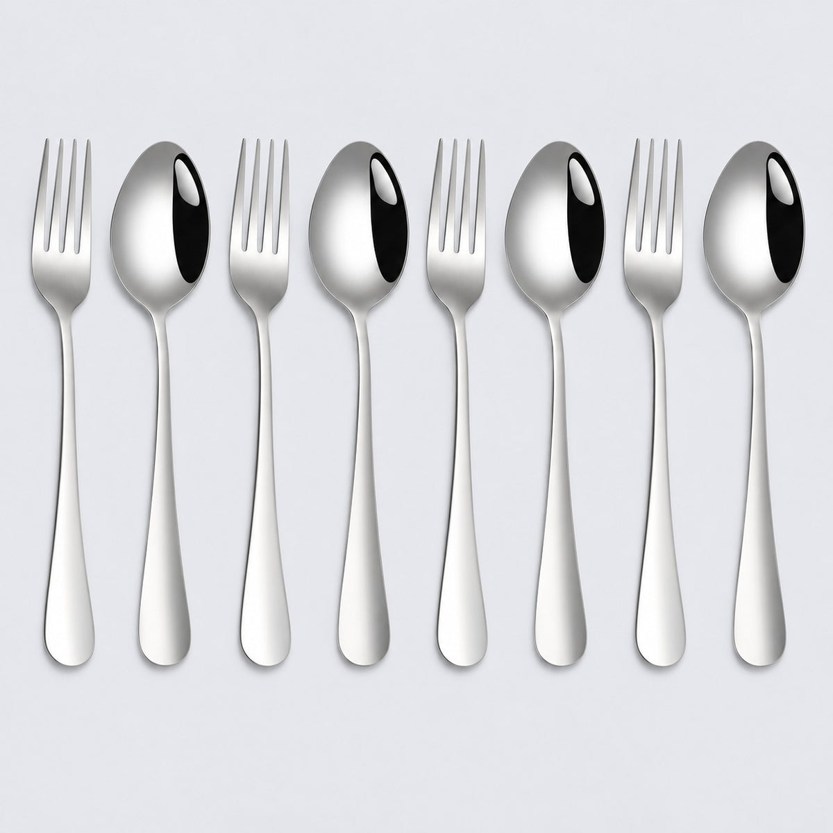 Set of 8 stainless steel spoons and forks arranged in four pairs on a pale gray background.