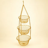 Gold Three Tier Hanging Fruit Basket hangs assembled against a pale gold studio background.