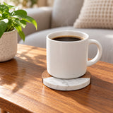Acacia wood and marble coaster keeps a coffee cup off a living room table.