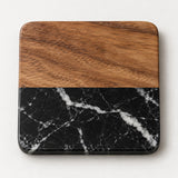Black Square acacia wood and black marble coaster with rounded corners on a pale backdrop.