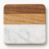 White Square coaster shows layered acacia wood above white marble on a pale studio backdrop.