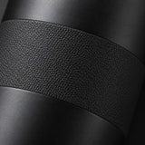 Macro view of the black bottle's matte stainless steel finish and textured grip surface.