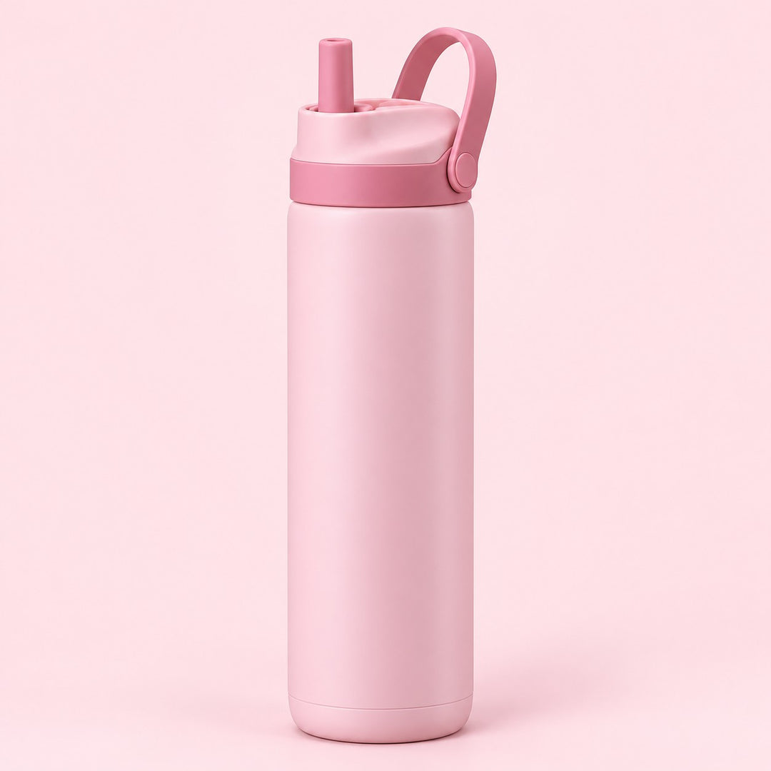 Pink 24 oz insulated straw bottle with raised carry loop against a pale blush background.