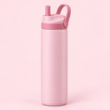 Pink 24 oz insulated straw bottle with raised carry loop against a pale blush background.