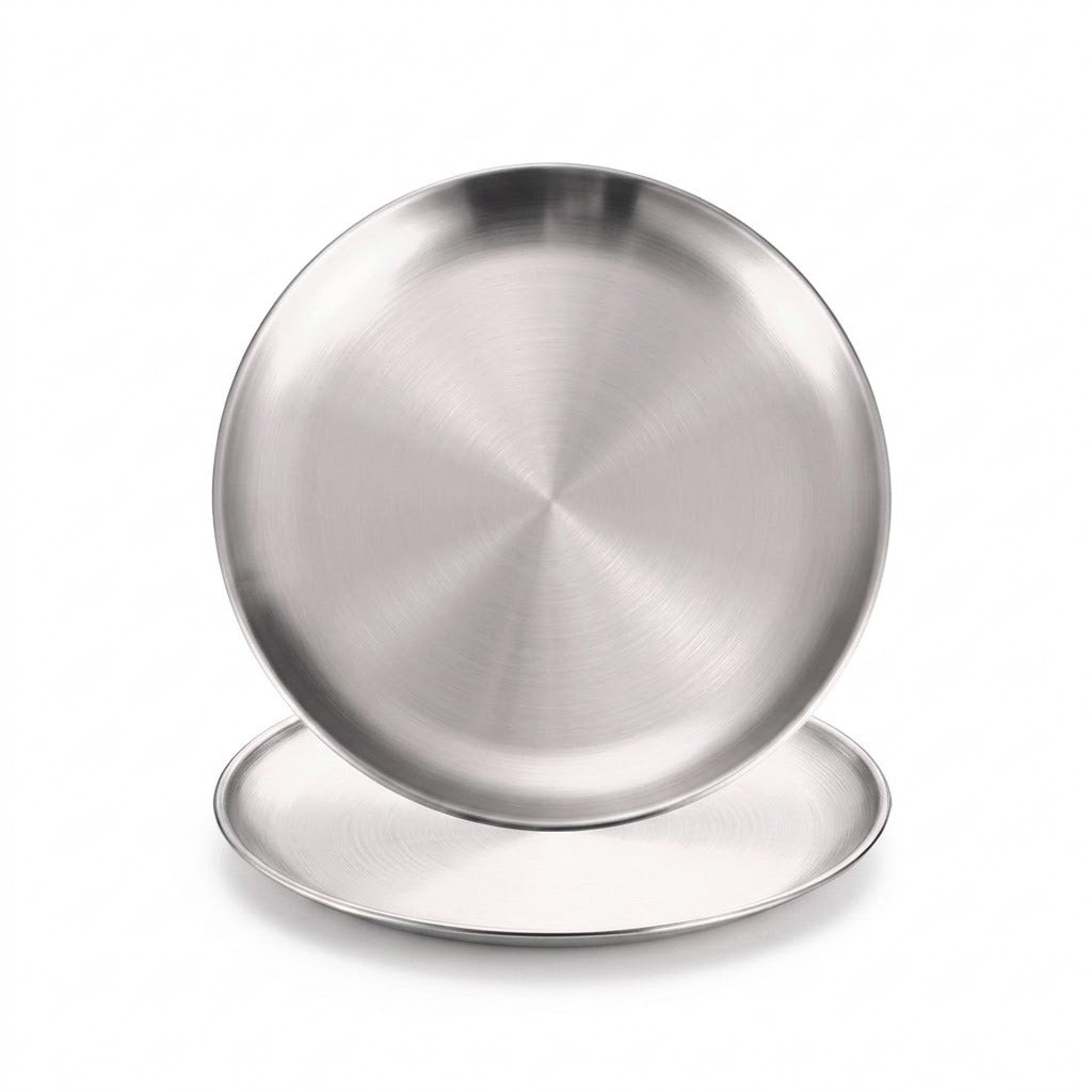 Two round brushed stainless steel plates or shallow pans stacked slightly offset on a clean white background.