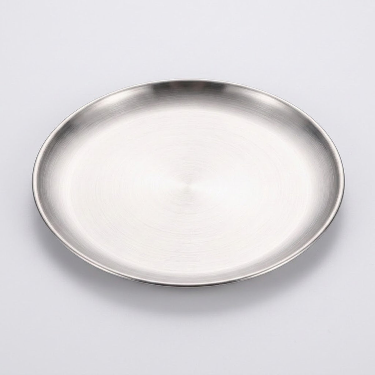 A round brushed stainless steel tray or shallow plate with a polished rim, shown from a top-down perspective on a light gray background.
