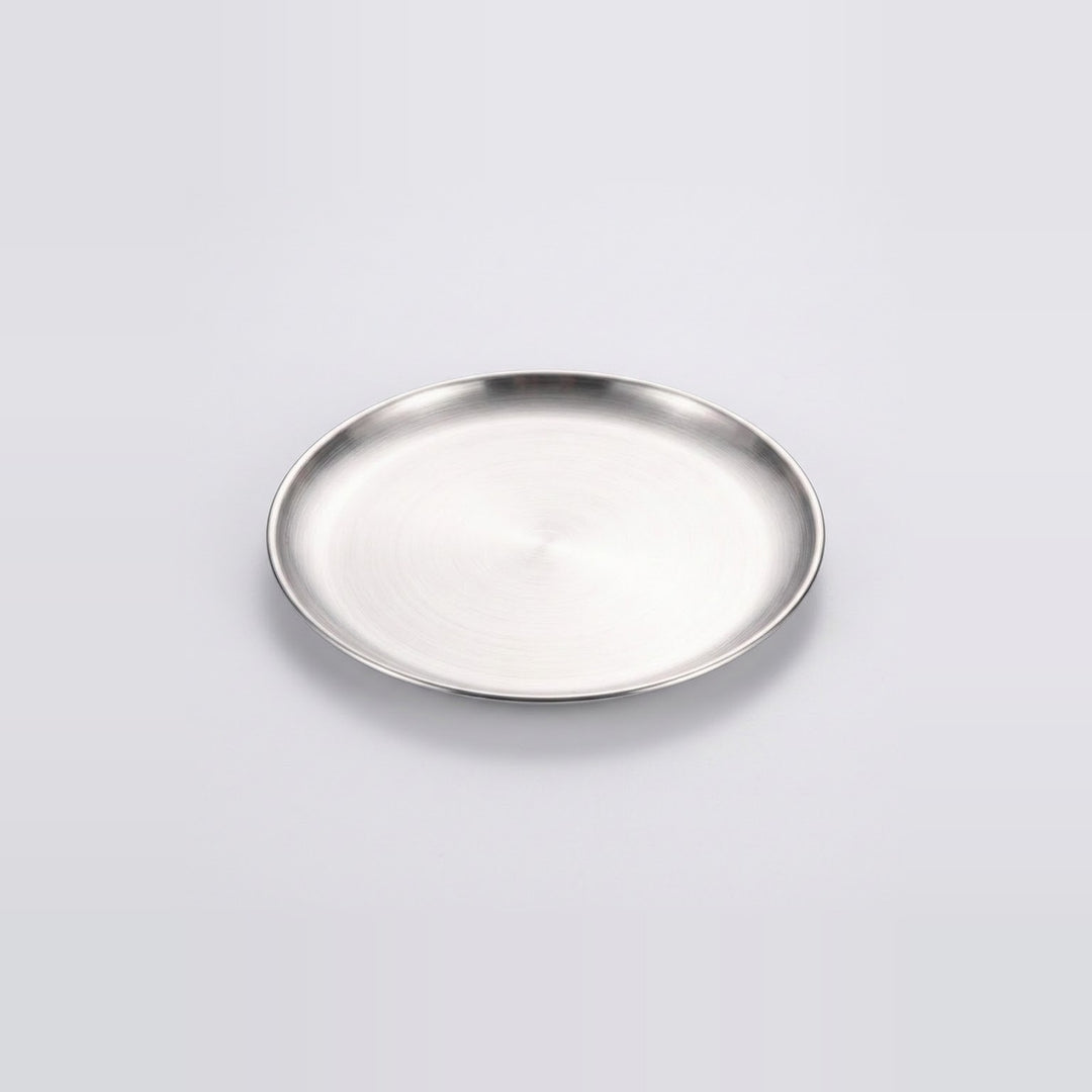 A round silver metal tray with a brushed finish and a raised rim, photographed on a clean light gray background.